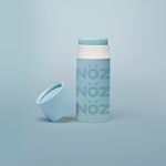 Load image into Gallery viewer, Blue Noz sunscreen standing with cap leaning on container
