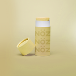 Load image into Gallery viewer, Yellow Noz sunscreen standing with cap leaning on container
