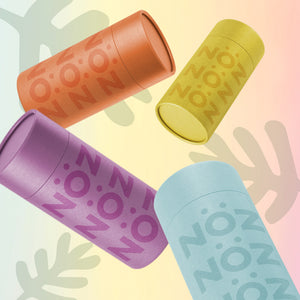 Purple, blue, yellow, and orange Noz sunscreen spread out in  blank space