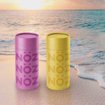 Load image into Gallery viewer, Purple and yellow Noz sunscreen on the  beach
